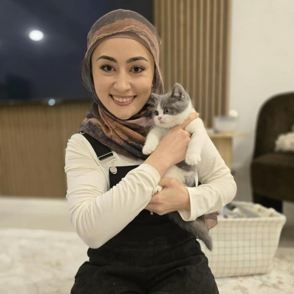 Elyssian Baker holding a grey and white British Shorthair kitten