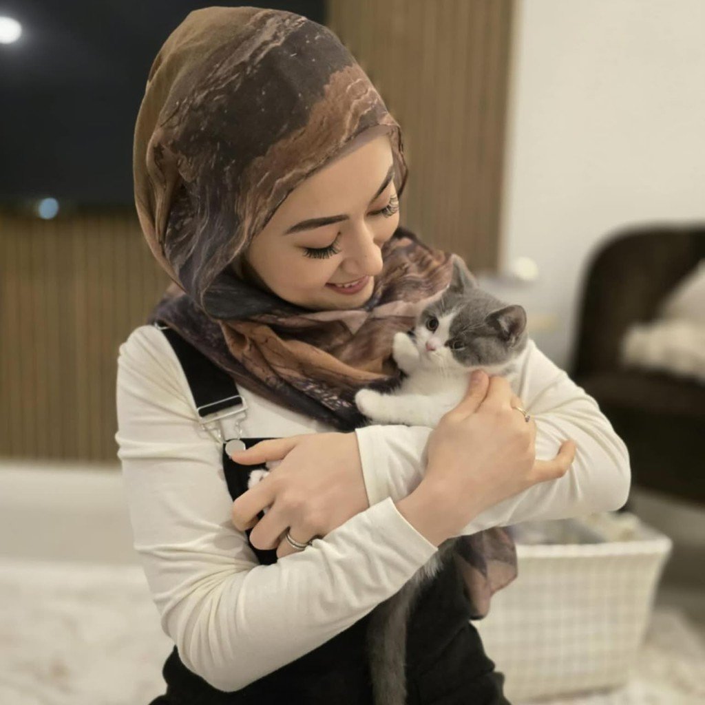 Elyssian holding a blue and white British Shorthair kitten